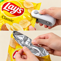 Handheld snack bag sealer and cutter in use